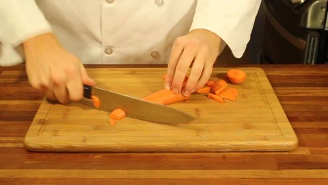 A cook chops carrots Stock Footage 92476566
