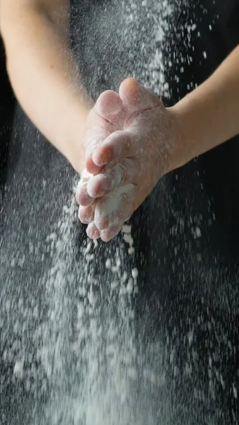 Cook clapping his hands with flour, flour splash vertical slow motion Video stock 288321052