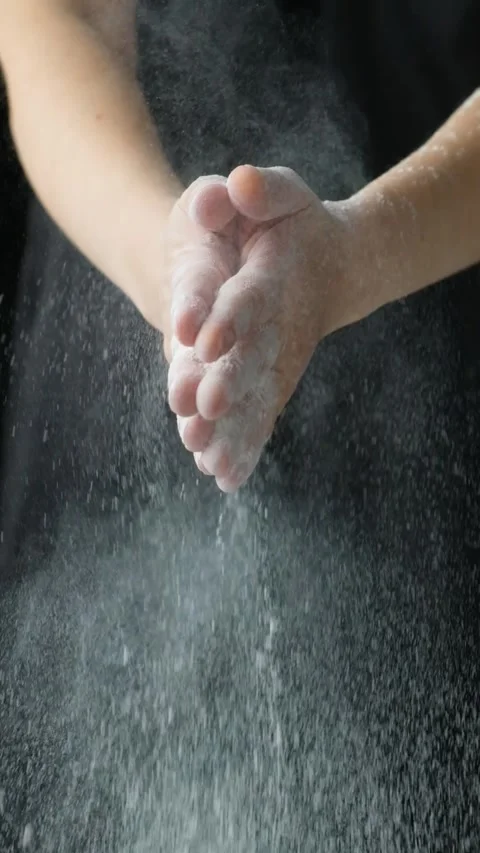 Cook clapping his hands with flour, flour splash vertical slow motion Video stock 293465905
