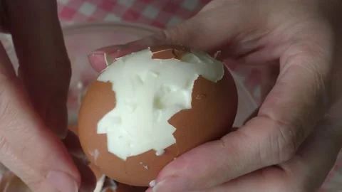 A cook cleans a boiled chicken egg with his hands Stock Footage 156670270