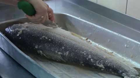 Cook cleans the fish by knife Stock Footage 143782129