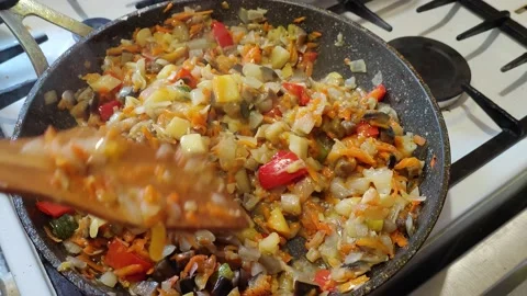 The cook cooks a stew in a frying pan Video stock 161982937