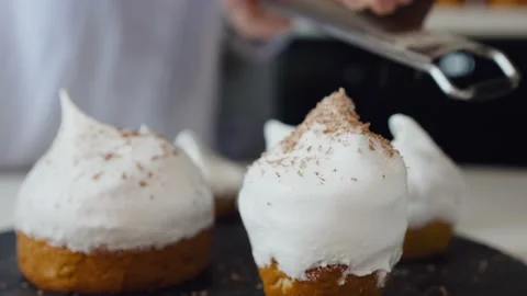 The cook covers the cake with chocolate chips. Traditional Easter cake with Stock Footage 147308593