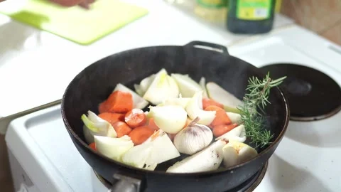 Cook crumbles spices and throws them to the fresh vegetables simmering in the Stock Footage 277204631