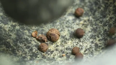 The cook crushing allspice in a stone mortar. 스톡 동영상 169798288