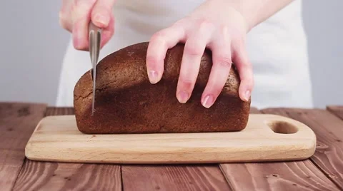 Cook Cut Black Bread on the Board. the Kitchen in the Restaurant. Slow Motion. 스톡 동영상 61839316