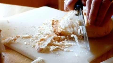 A cook, cut some dry bread into small cubes for the dough of the Tyrolean Video stock 95232491