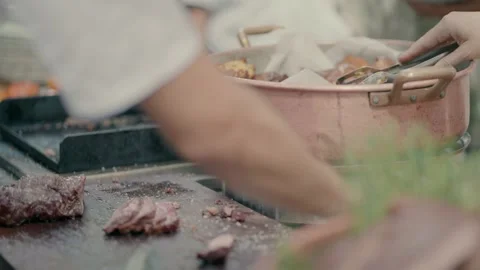 A cook cuts and divides meat at the buffet Video stock 236630109