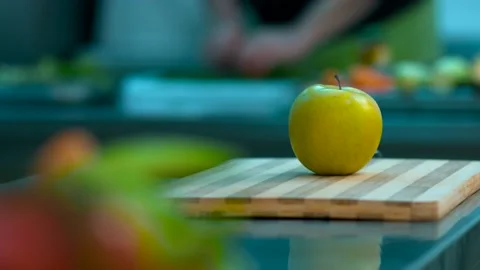 Cook cuts an apple Stock Footage 134471584