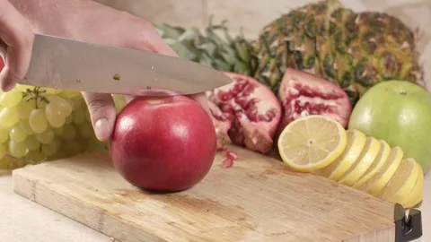 The cook cuts an apple into slices Stock Footage 84830233