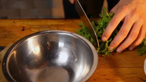 The cook cuts arugula, puts it in a bowl, adds strawberries, cherry tomatoes Stock Footage 123774121