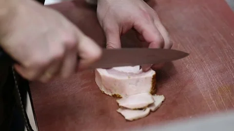 Cook cuts bacon on the board Stock Footage 76082454