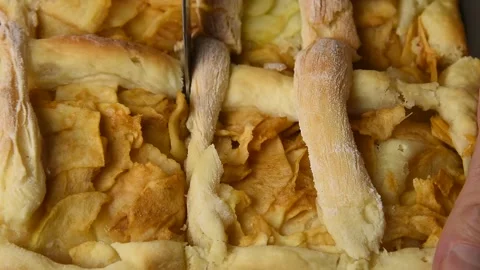Cook cuts a baked pie with a knife. Stock Footage 145086476