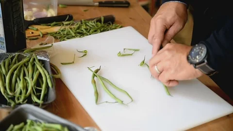 Cook cuts bean pods Stock Footage 81544616