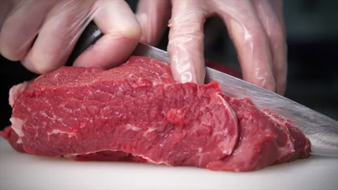 Cook cuts beef meat with a knife Stock Footage 204718040