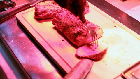 The cook cuts a beef steak with a knife, hands cut the meat with a knife Stock Footage 145855452