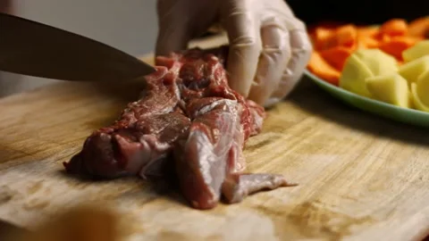 The cook cuts the beef in very pleasant atmosphere. 4k cinematography video Stock Footage 156618261