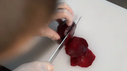 The cook cuts the beets with a knife. Cook prepares beetroot appetizer Stock Footage 126447102