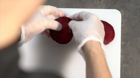 The cook cuts the beets with a knife. Thin beet slices. Appetizer Stock Footage 126447081