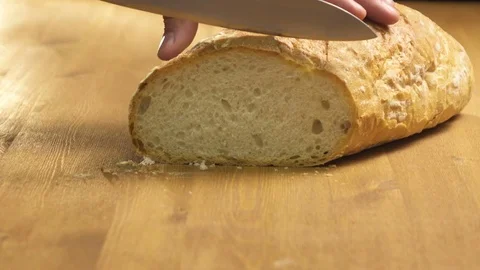The cook cuts the bread into thin slices Stock Footage 76422431