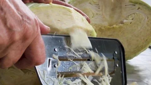 Cook cuts cabbage with a knife Stock Footage 306448656