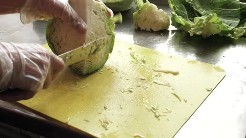 Cook cuts the cabbage into small pieces Stock Footage 133110156