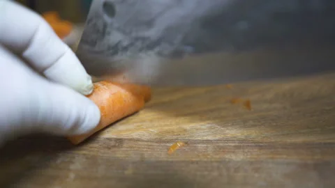Cook cuts carrots .Close up scene Stock Footage 169744652