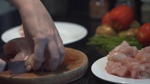 The cook cuts the chicken breast in half, raw chicken, chef cooks chicken 스톡 동영상 82592269