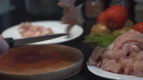The cook cuts the chicken breast in half, raw chicken, chef cooks chicken Stock Footage 82592323