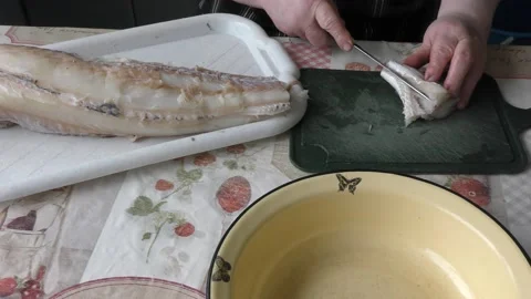 The cook cuts cod fish into pieces Stock Footage 170936223