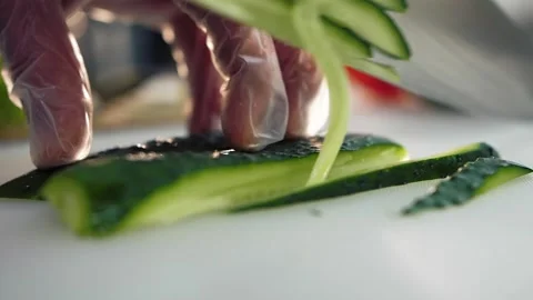 Cook cuts a cucumber with a knife Video stock 151036637