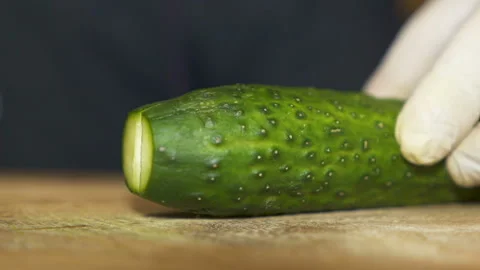Cook cuts cucumber.Close up scene Stock Footage 169744962