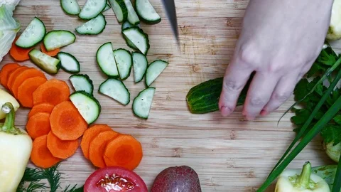 Cook cuts cucumbers Stock Footage 78057704