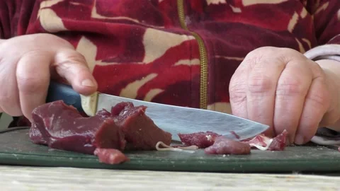 The cook cuts deer meat with a knife. healthy food concept Video stock 148999817
