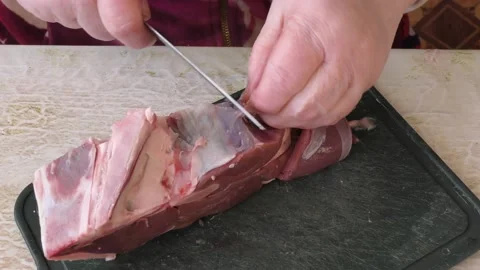The cook cuts deer meat with a knife. healthy food concept 스톡 동영상 149000187