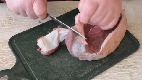 The cook cuts deer meat with a knife. healthy food concept Stock Footage 149000694