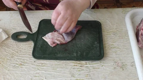 The cook cuts the deer meat with a knife.  healthy food concept 動画素材 153255713