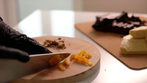 The cook cuts dried apricot Stock Footage 157277616