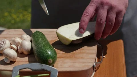 The cook cuts the eggplant on the table with a knife Stock Footage 228616912
