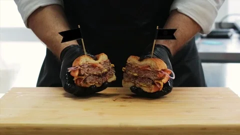 The cook cuts the finished burger Stock Footage 127202955