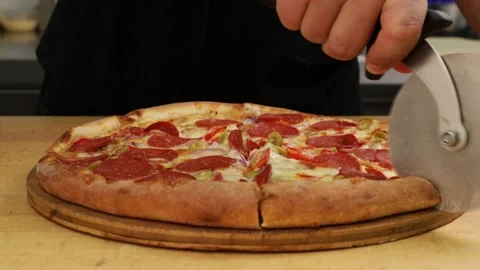 The cook cuts the finished pizza. Stock Footage 160968506
