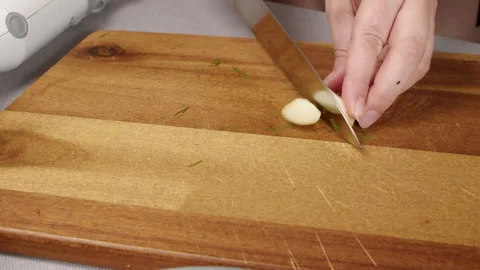 Cook cuts garlic Stock Footage 165598103