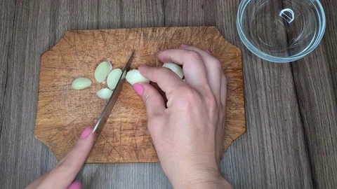 Cook Cuts The Garlic With A Knife. Stock Footage 166703153