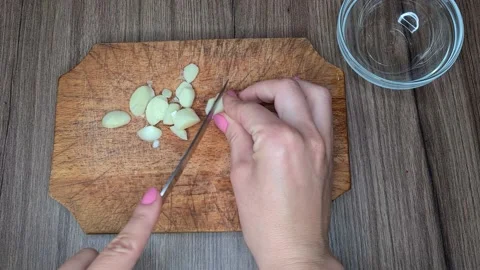Cook Cuts The Garlic With A Knife. Stock Footage 166703176