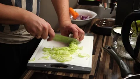 Cook cuts green celery on a cutting board on the table. Time lapse Stock Footage 267215562