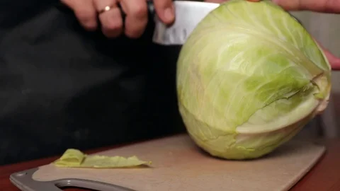 The cook cuts the head of cabbage in half Stock Footage 129338853