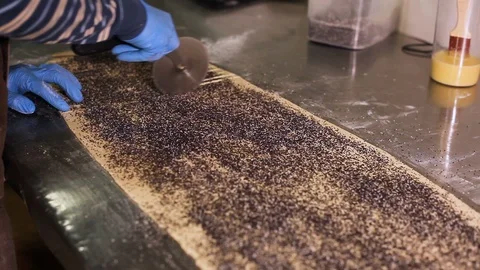 Cook cuts a huge sheet of dough with a steel wheel knife Video stock 106484166