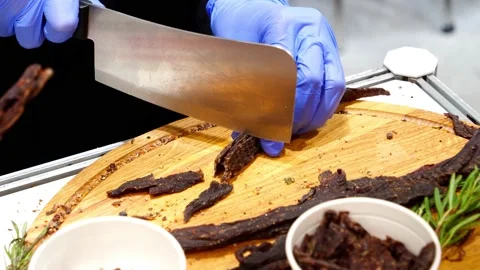 The cook cuts the jerky from veal Stock Footage 232578712