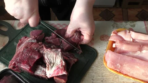 The cook cuts with a knife raw venison, deer meat Stock Footage 170575113