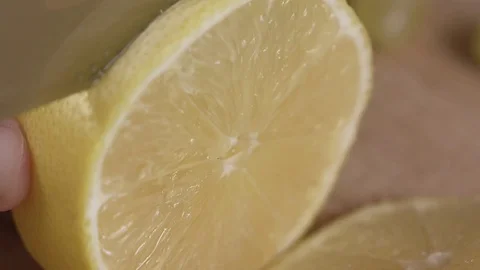 The cook cuts a lemon close up Stock Footage 84794152